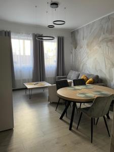 a living room with a table and a couch at Apartament Olesno in Olesno