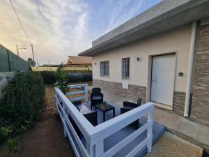 a fence in front of a house with a table and chairs at Casa Gavedi in Avola