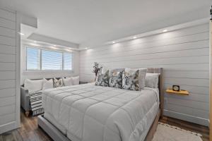 a white bedroom with a large bed in it at Summit 803 - Luxury Beach Resort Condo 1-6 People in Panama City Beach +15 photos