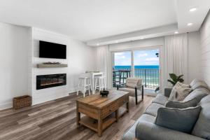 a living room with a couch and a fireplace at Summit 808 - Luxury Beach Resort Condo 1-6 People in Panama City Beach
