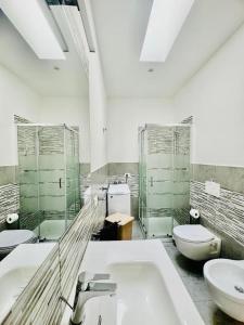a bathroom with two toilets and a sink and a sink at Casa Gavedi in Avola +14 photos