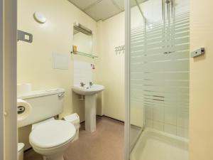 a bathroom with a toilet, sink, and shower at LSE Bankside House in London