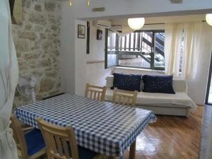 a living room with a table and a couch at Lieber Himell 1 in Betina +32 photos