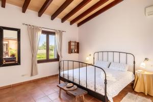 a bedroom with a bed and a window at Son Catiu in Inca +24 photos