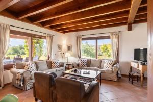 a living room with couches and a tv at Son Catiu in Inca