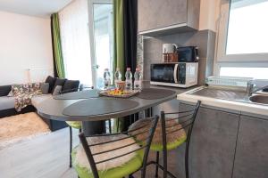 a kitchen with a table and chairs in a room at Elysian by Coressi in Braşov