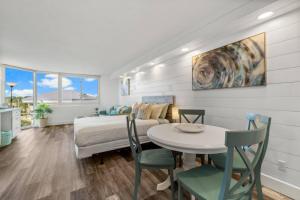 a bedroom with a bed and a table and chairs at Top Of The Gulf 410 Beach Front Condo - Renovated! in Panama City Beach +20 photos