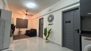 a living room with a tv and a door at Sleek Stay in Furena +19 photos