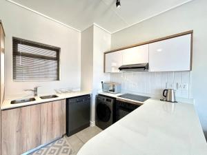 a kitchen with a sink and a dishwasher at Blissnest in Ballito