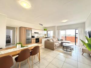 a living room with a couch and a table at Shoreline Sanctuary! in Ballito