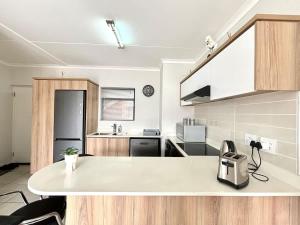 a kitchen with a white counter top in a room at The Pearl in Ballito