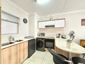 a kitchen with a sink and a dishwasher at The Pearl in Ballito