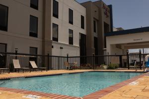 a swimming pool in front of a building at Hampton Inn Victoria in Victoria