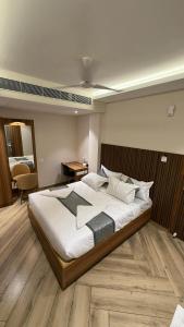 a bedroom with a large bed in a room at Grand Sea Way in Chennai +4 photos