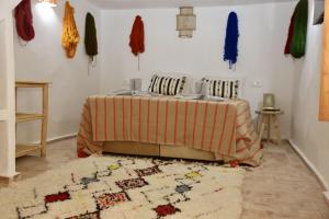 Un dormitorio con una cama y una alfombra en el suelo. en Riad Dar Familya, en Marrakech
