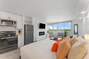 a living room with a couch and a kitchen at Top Of The Gulf 622 - Beach Front Condo Resort in Panama City Beach