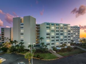 a large building with a parking lot in front of it at Beach Front Ocean View Condo - Top Of The Gulf 804 in Panama City Beach
