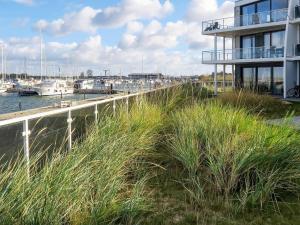 a building next to a marina with boats in the water at 12 person holiday home in Wendtorf in Wendtorf
