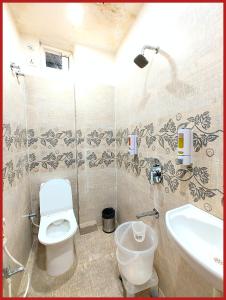 a bathroom with a toilet and a sink at Hotel New Kashi - Grand Near Vishwanath Temple - Fully Air Conditioned Rooms - #Restaurant #Wi-fi #Lift # Parking Facilities - A Top Rated Hotel in Varanasi