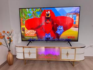 a flat screen tv sitting on top of a table at Apartament ELLA in Tulcea
