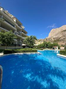 a large swimming pool in front of a building at DIVINO LUC, frente a la Cala Racó del Corb in Altea