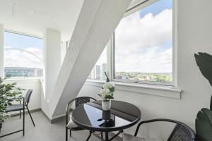 a dining room with a table and chairs and a window at Luxury 3-Bed Apt in Wembley Park in London