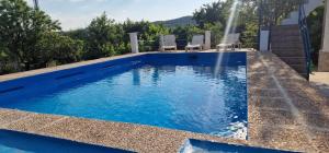 a swimming pool with a water fountain at Villa Josefina in Puerto Lápice