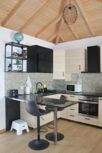 a kitchen with a large island in a room at Villa Barbosa in Quintiães