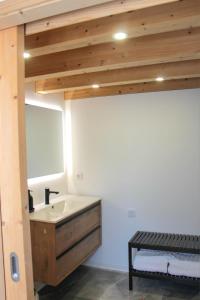 a bathroom with a sink and a mirror at Villa Barbosa in Quintiães +9 photos