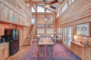 a kitchen and living room of a wooden cabin at Cliffside Cabin @ High Hope Ranch Cowboy POOL! in Glen Rose