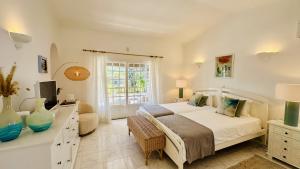 a bedroom with a bed and a tv and a window at Villa Verde by Check-in Portugal in Vilamoura +30 photos