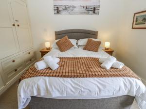 a bedroom with a large bed with two night stands at Centenary Cottage in Skipton