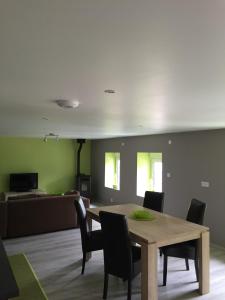 a dining room with a table and chairs at A la Ferme Bleue in Nayemont-les-Fosses