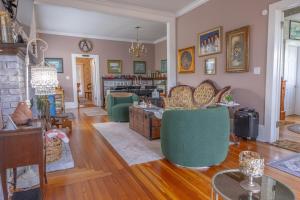 a living room filled with furniture and a fireplace at The Abbey House in Daytona Beach
