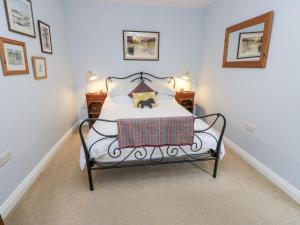 a bedroom with a bed with a dog on it at The Treetop in Settle