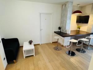 a living room with a couch and a table and chairs at MMM HOME Train Station 4 in Mestre