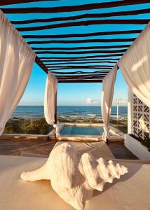 a bedroom with a view of the ocean at Ikal Island Garden in Isla Mujeres