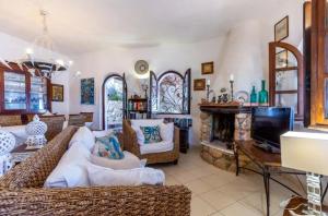 a living room with a couch and a fireplace at Villa Renata Torre delle Stelle in Torre delle Stelle