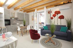 a living room with a blue couch and red chairs at Airport Palace Cinisi in Cinisi