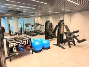 a gym with several treadmills and exercise equipment at Setai, Aquamaris- pé na areia in João Pessoa