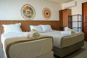 deux lits dans une chambre d'hôtel avec des serviettes dessus dans l'établissement Casa em Milagres/AL | 3 suítes, vista-mar, piscina, à Barra do Camaragibe 25 autres photos