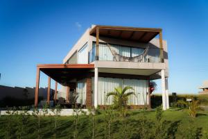 une maison avec un balcon sur le côté dans l'établissement Casa em Milagres/AL | 3 suítes, vista-mar, piscina, à Barra do Camaragibe