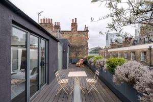 a deck with two chairs and a table on a building at Magic Moments - London Bridge - by Frankie Says in London