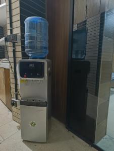 a cooler with a container of water on top of it at Ghumakkads Hostel Near IGI Airport & Aerocity in New Delhi