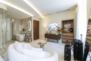 a living room with a white couch and a piano at Le Dortoir Boutique Suites in Nice +272 photos