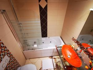 a bathroom with a bath tub and a sink at VILLA Bose in Brela +182 photos
