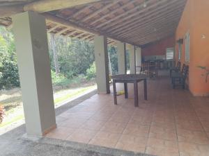 a patio with a table and chairs on it at São Francisco in Joanópolis