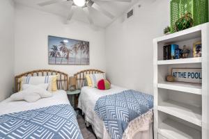 a bedroom with two beds and a table at Waterfront, Pet-Friendly Condo with Pool, Spa, and Fitness Center near Downtown Sarasota in Sarasota +56 photos
