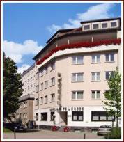 a large white building with red decorations on it at Hotel am Feuersee in Stuttgart