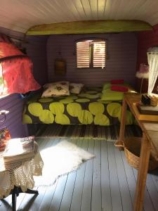 a small room with a bed in a house at Roulotte Tzigane Bord du Ruisseau in Marsanne